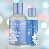 Two bottles of Sliquid Swirl Blue Raspberry Flavored Lubricant, a sugar-free, water-based intimate product from the brand Sliquid. The set includes a 4.2 oz larger bottle and a 2 oz smaller one, elegantly displayed against a blurred background with colorful bokeh lights.